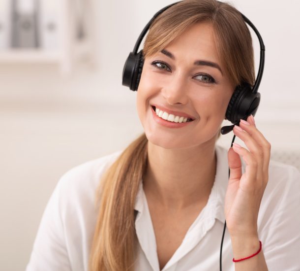 Smiling Woman In Headset Working In Call Center Office